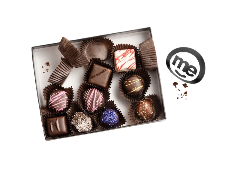Box of assorted chocolates alongside ME branding