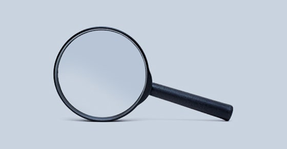 Magnifying glass on a light grey background