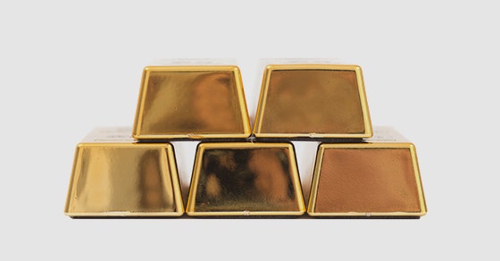 Stack of five gold bars arranged in a pyramid