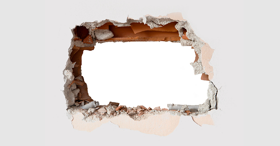 Large hole broken through a plaster wall